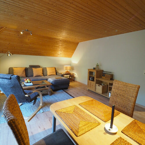 Wohnzimmer mit Esstisch und Balkon